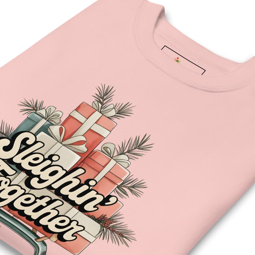 Pink t-shirt with Christmas-themed design featuring presents and 'Sleighin' Together' text.