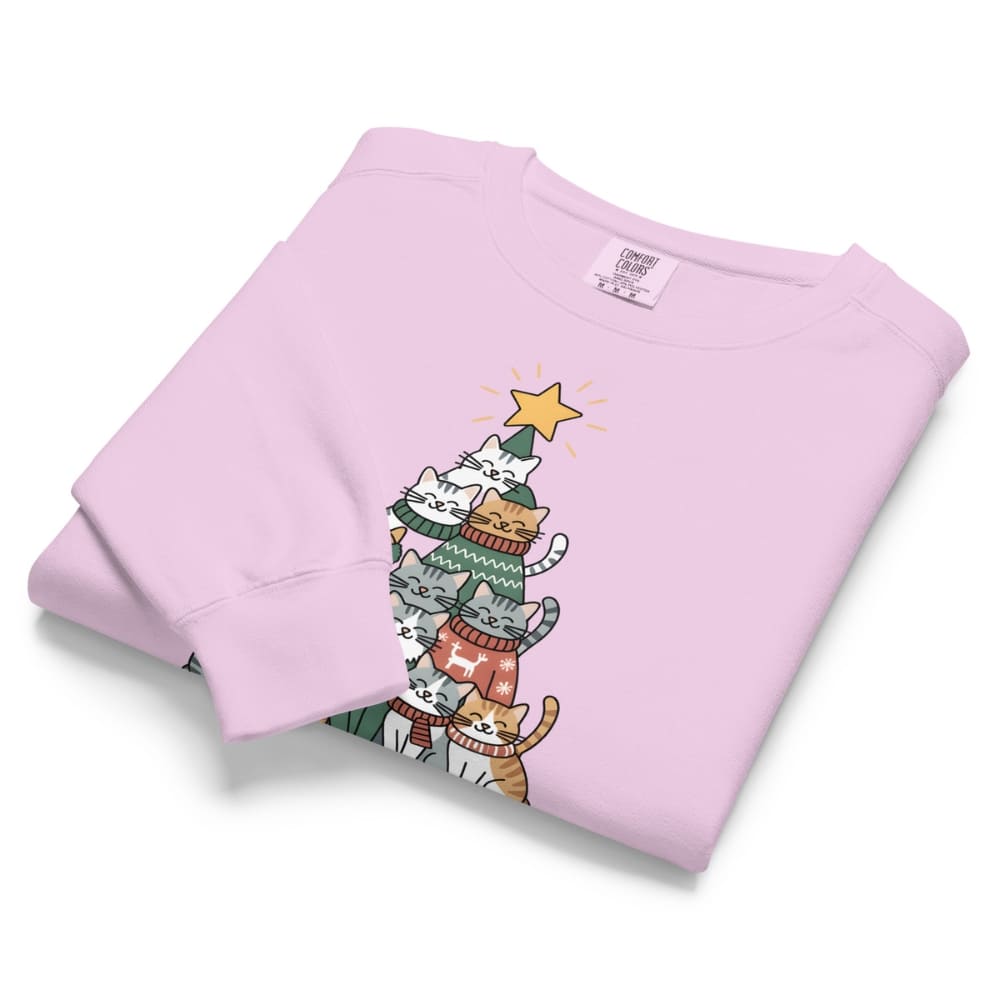 Folded light purple sweatshirt with cartoon cats in sweaters and a star on a white background
