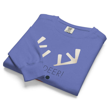 Folded blue sweatshirt with white graphic and text on a white background