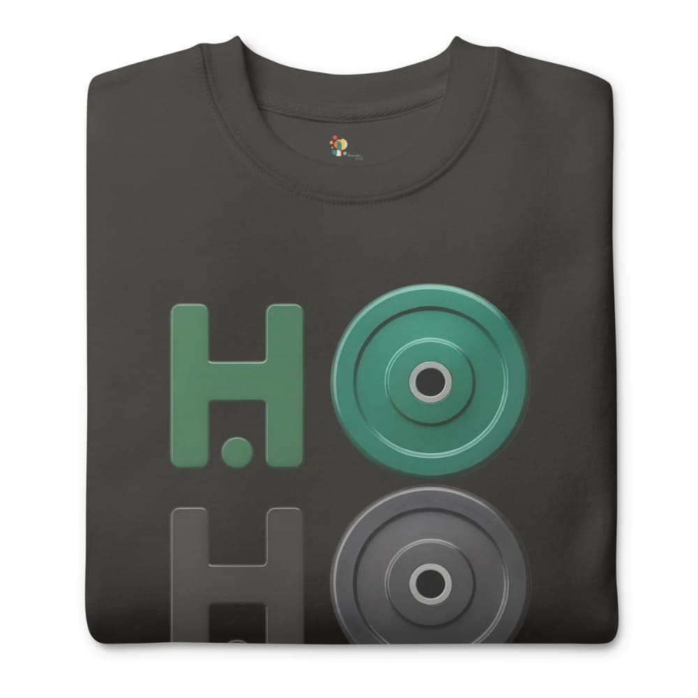 Folded black t-shirt with green and gray graphic design on a white background