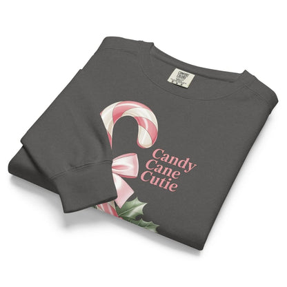 Folded dark gray sweatshirt with candy cane design and 'Candy Cane Cutie' text on a white background