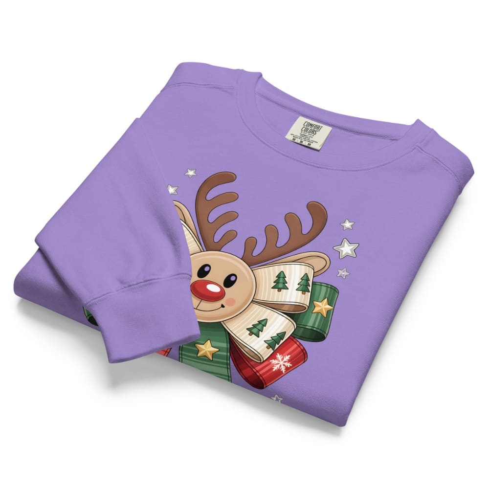 Folded purple sweatshirt with a reindeer design on a white background