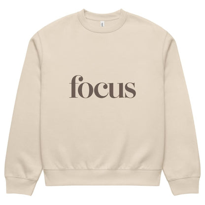 Beige sweatshirt with 'focus' text on a white background