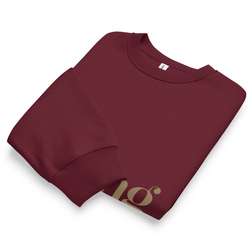Folded maroon sweatshirt with a logo on a white background
