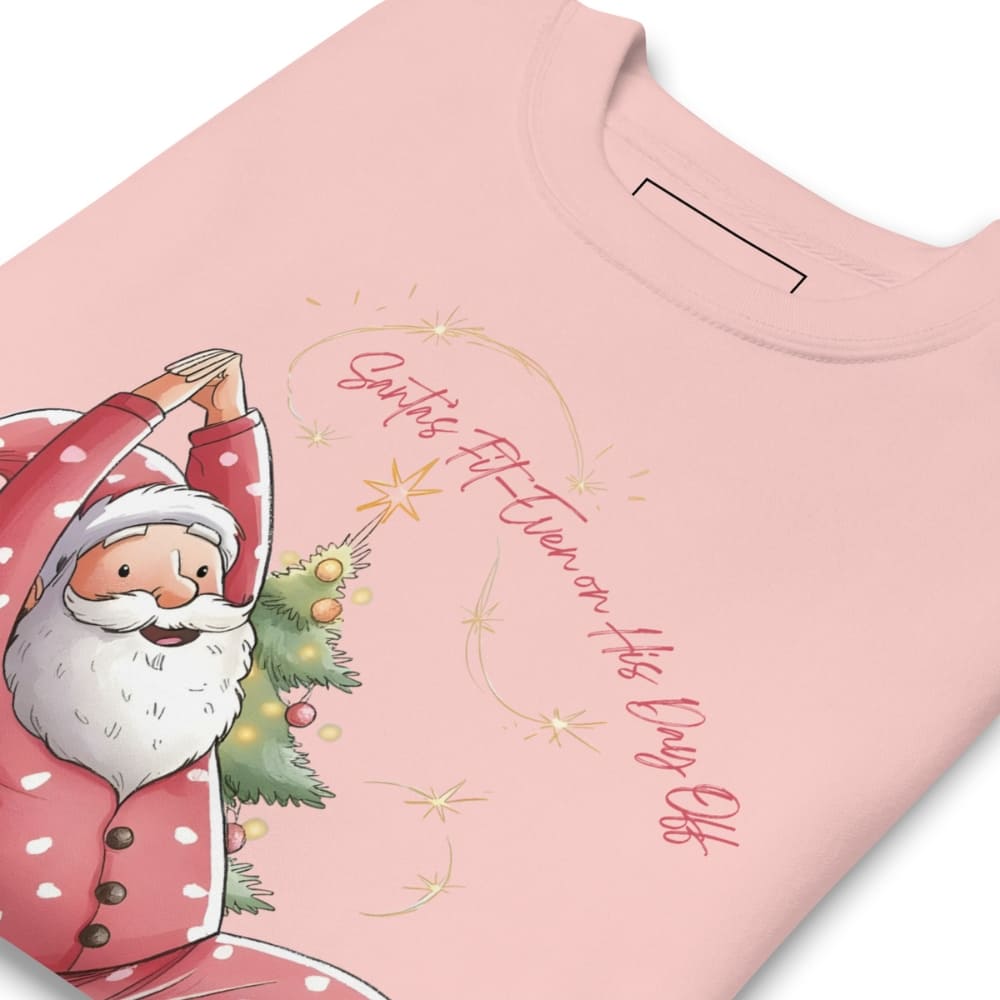 Pink t-shirt with a cartoon Santa Claus holding a Christmas tree and text on a white background