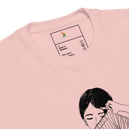Close-up of a pink t-shirt with a label and an illustration of a woman on a white background