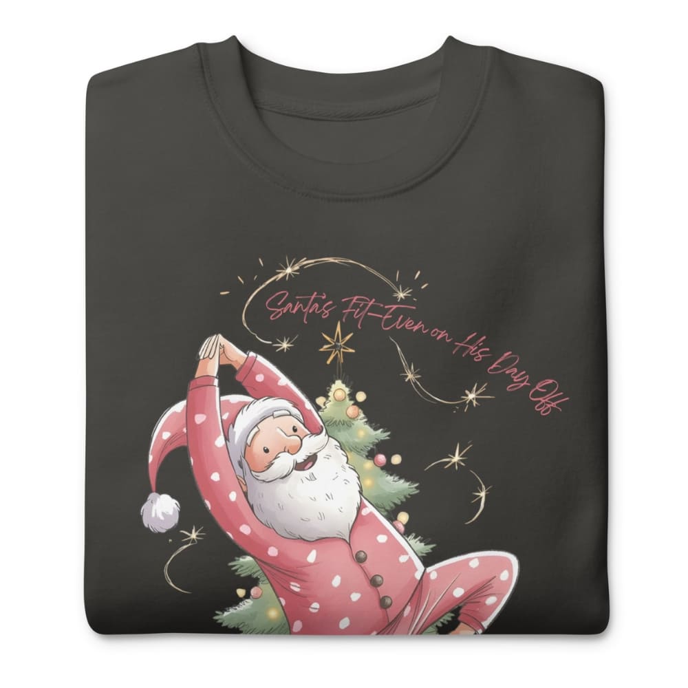 Black t-shirt with a design of Santa Claus doing yoga and text 'Santa's Fit Even on His Day Off' on a white background.