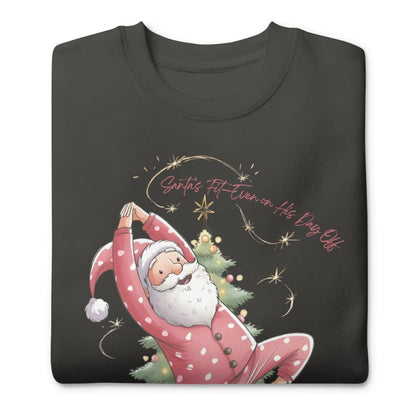 Black t-shirt with a design of Santa Claus doing yoga and text 'Santa's Fit Even on His Day Off' on a white background.