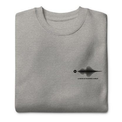 Folded gray sweatshirt with a black graphic design on a white background