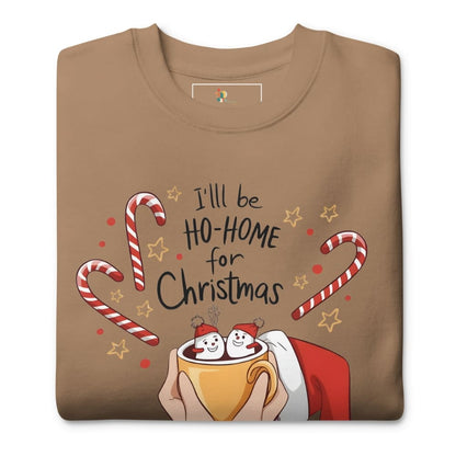 Folded brown t-shirt with Christmas-themed design featuring candy canes, stars, and a cup of hot chocolate.