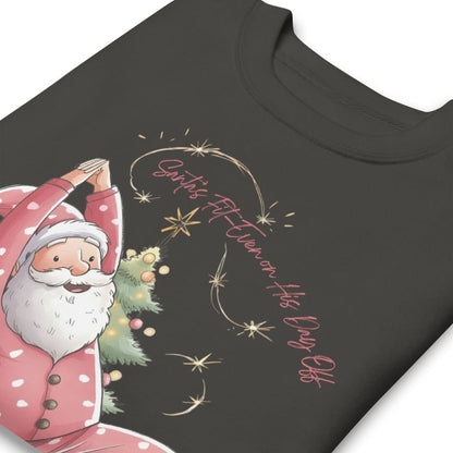 Black t-shirt with a festive design of Santa Claus holding a Christmas tree and stars.