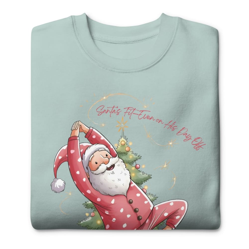 Folded light blue sweatshirt with Santa Claus doing yoga design on a white background