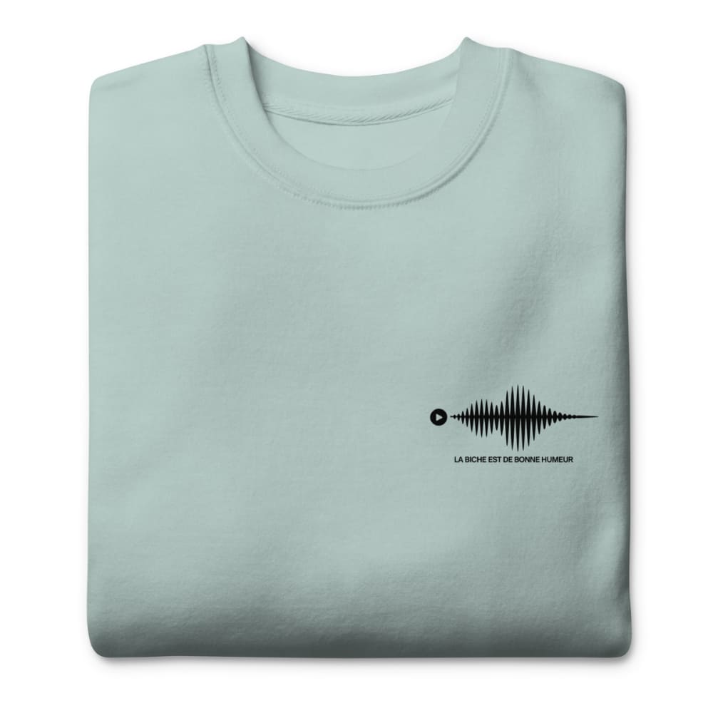Folded light blue sweatshirt with a black graphic design on a white background