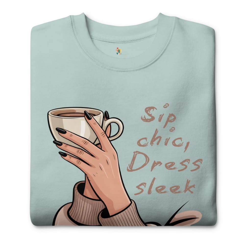 Light blue sweatshirt with a hand holding a coffee cup and text 'Sip, chic, Dress, sleek' on a white background