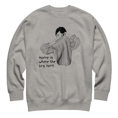 Gray sweatshirt with a graphic of a woman holding a bra and text 'Home is where the bra isn't' on a white background.