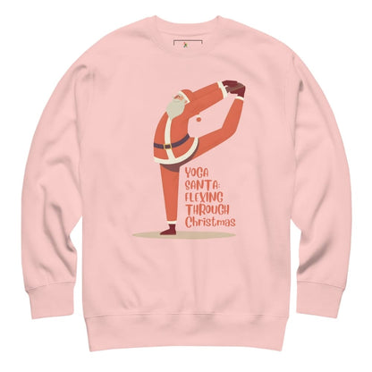 Pink sweatshirt with a graphic of Santa Claus doing yoga and text 'Yoga Santa Flexing Through Christmas' on a white background.