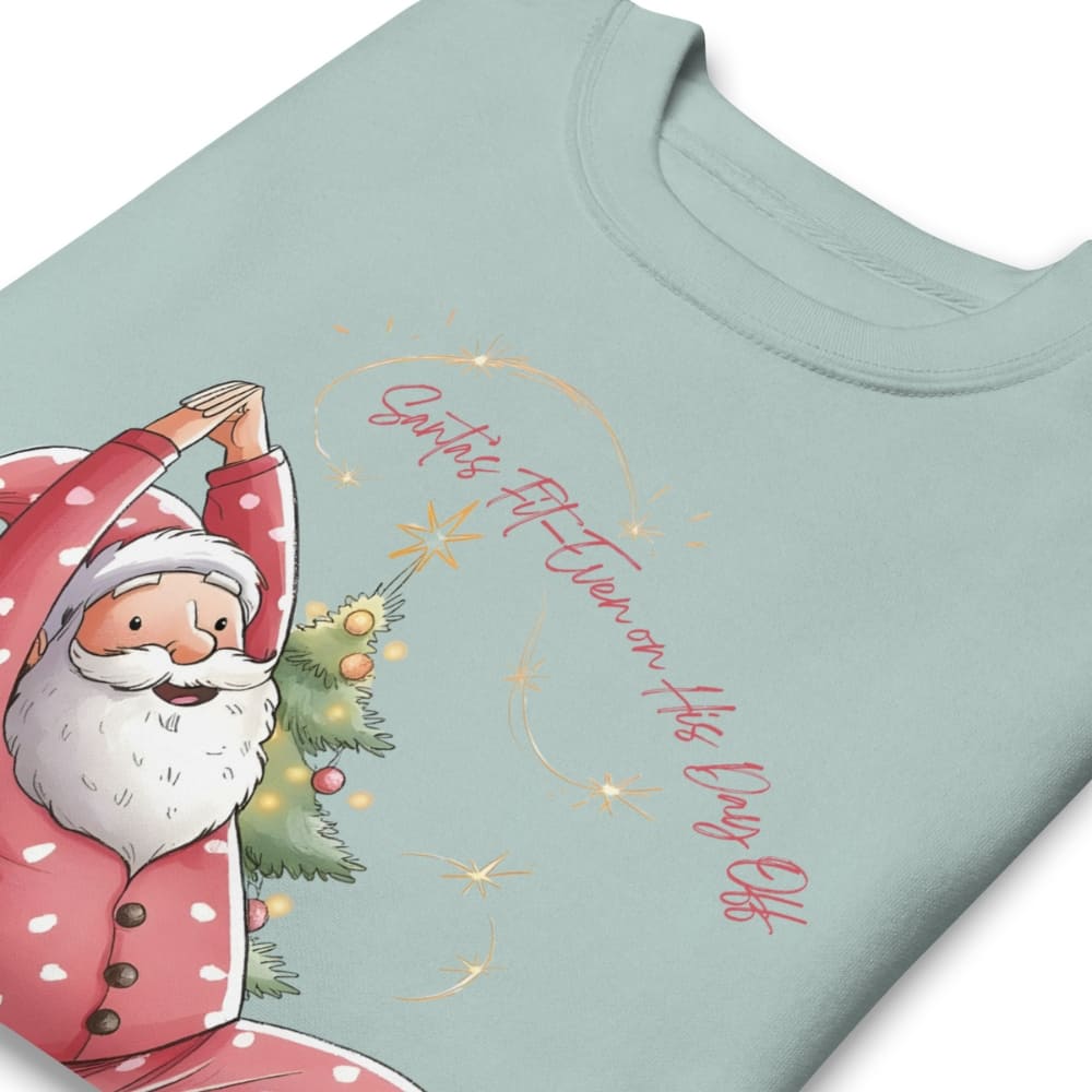 Light blue t-shirt with a cartoon Santa Claus holding a Christmas tree and text on a white background