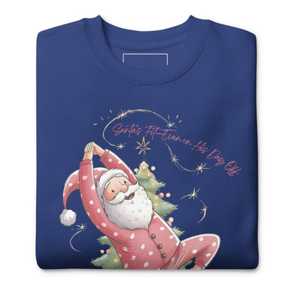 Blue sweatshirt with a cartoon Santa Claus doing yoga pose and Christmas tree design on a white background.