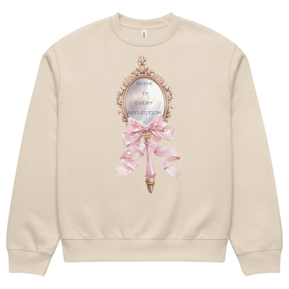 Beige sweatshirt with decorative mirror and pink bow design on a white background