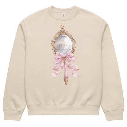 Beige sweatshirt with decorative mirror and pink bow design on a white background