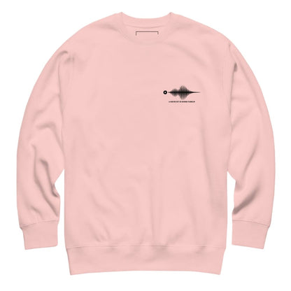 Pink sweatshirt with a black graphic on the chest against a white background