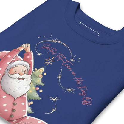 Blue t-shirt with a festive design of Santa Claus holding a Christmas tree and text on a white background.