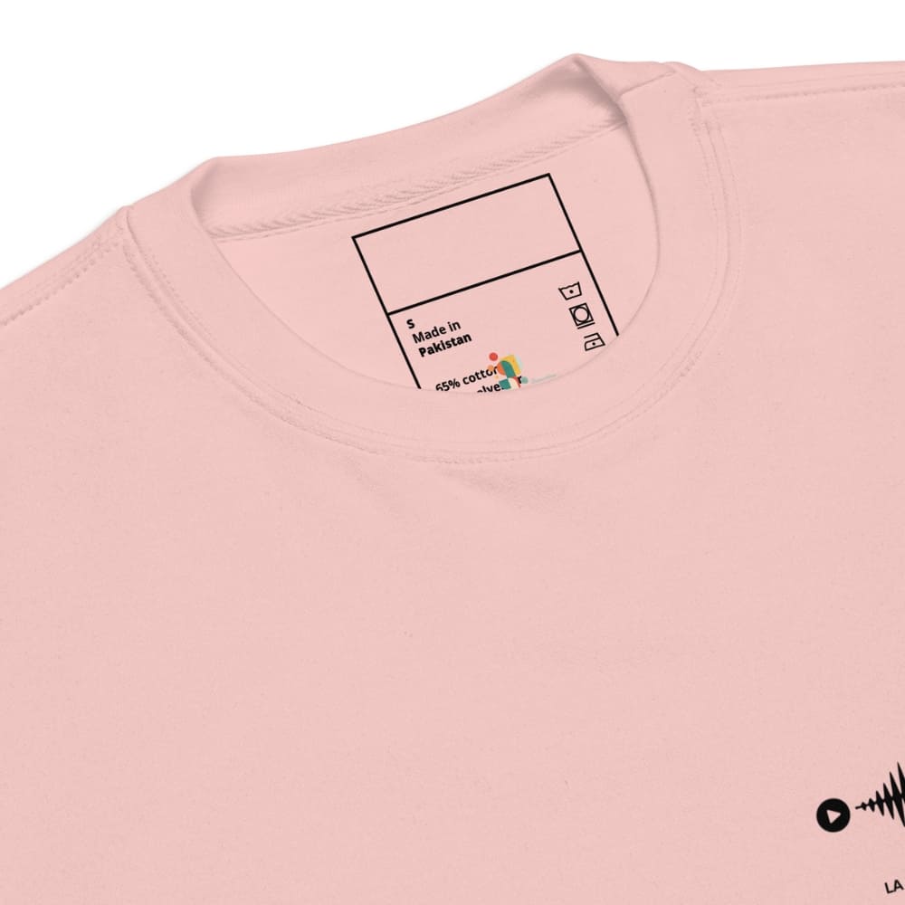 Close-up of a pink t-shirt with a label on the collar displaying fabric information.