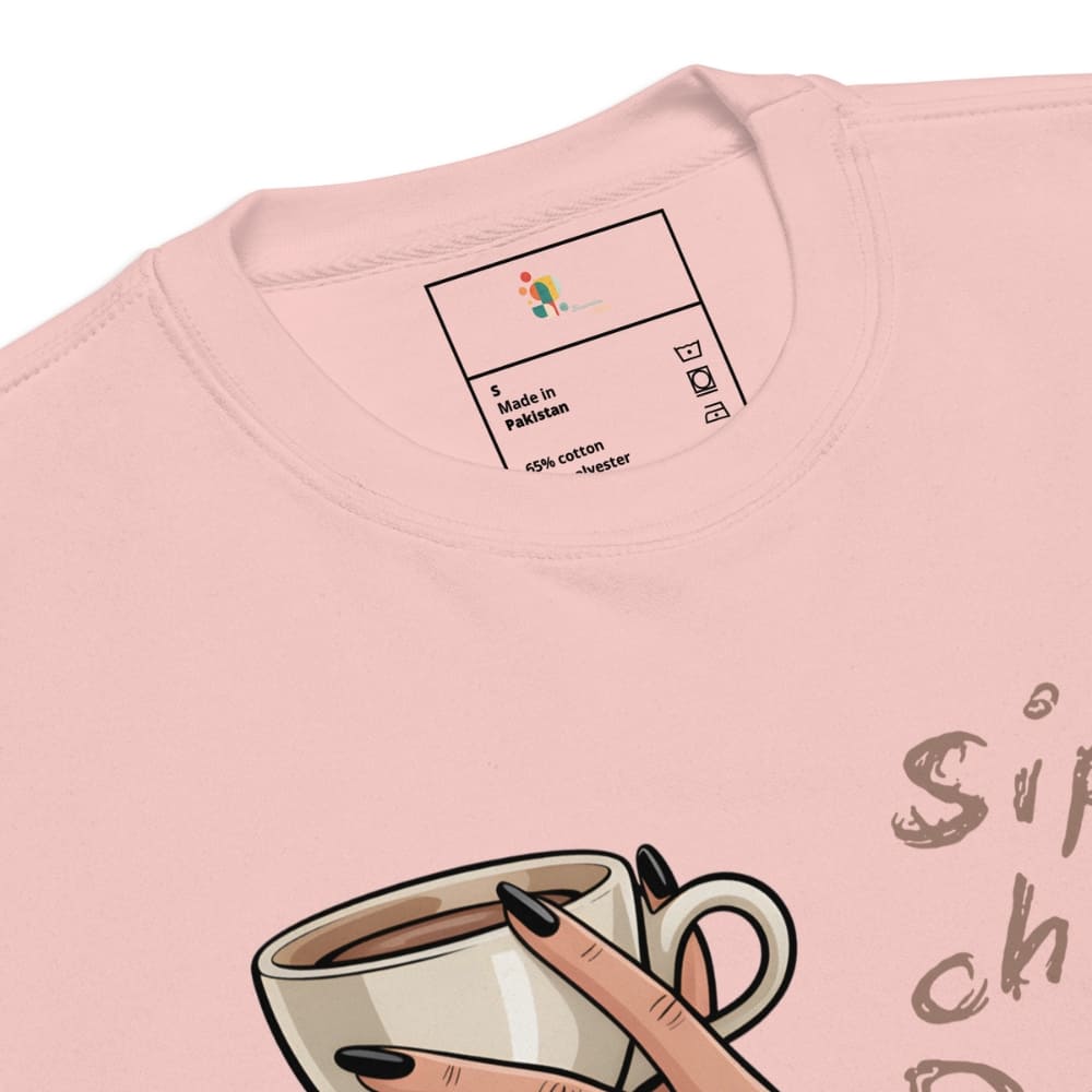 Pink t-shirt with a coffee cup graphic and brand label on a white background