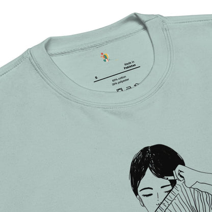 Light blue t-shirt with a graphic of a woman getting her hair done and a label on the collar.