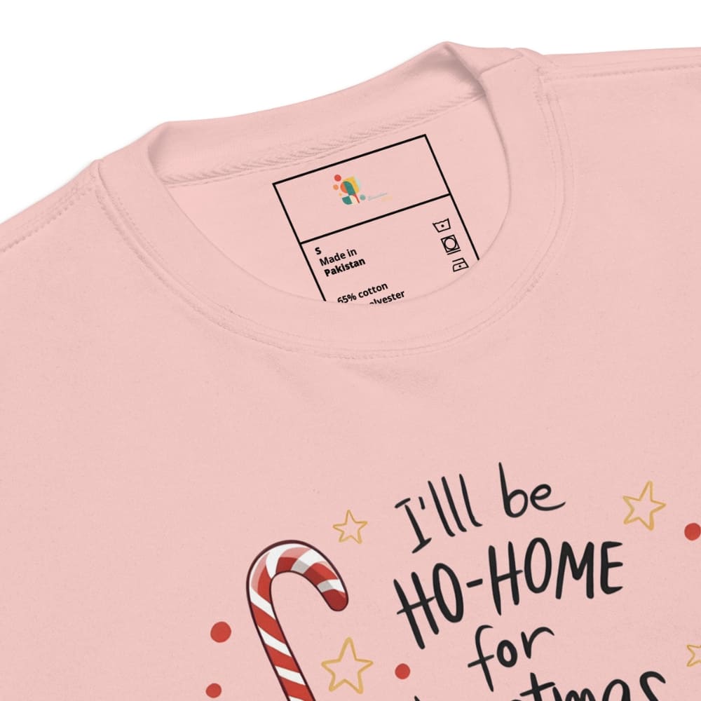 Pink shirt with candy cane and text design, brand label visible.