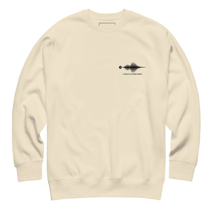 Beige sweatshirt with a black graphic on the chest against a white background