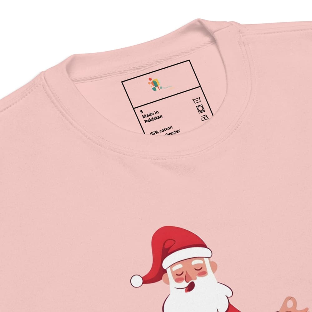 Pink shirt with a cartoon Santa Claus design and label on a white background