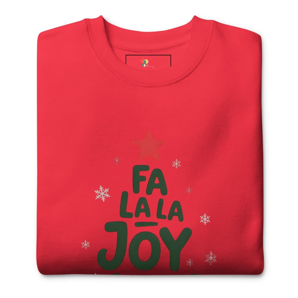 Folded red t-shirt with 'Fa La La Joy' text and star design on a white background