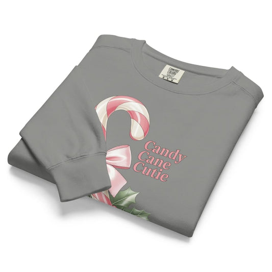 Folded gray sweatshirt with candy cane design and 'Candy Cane Cutie' text on a white background