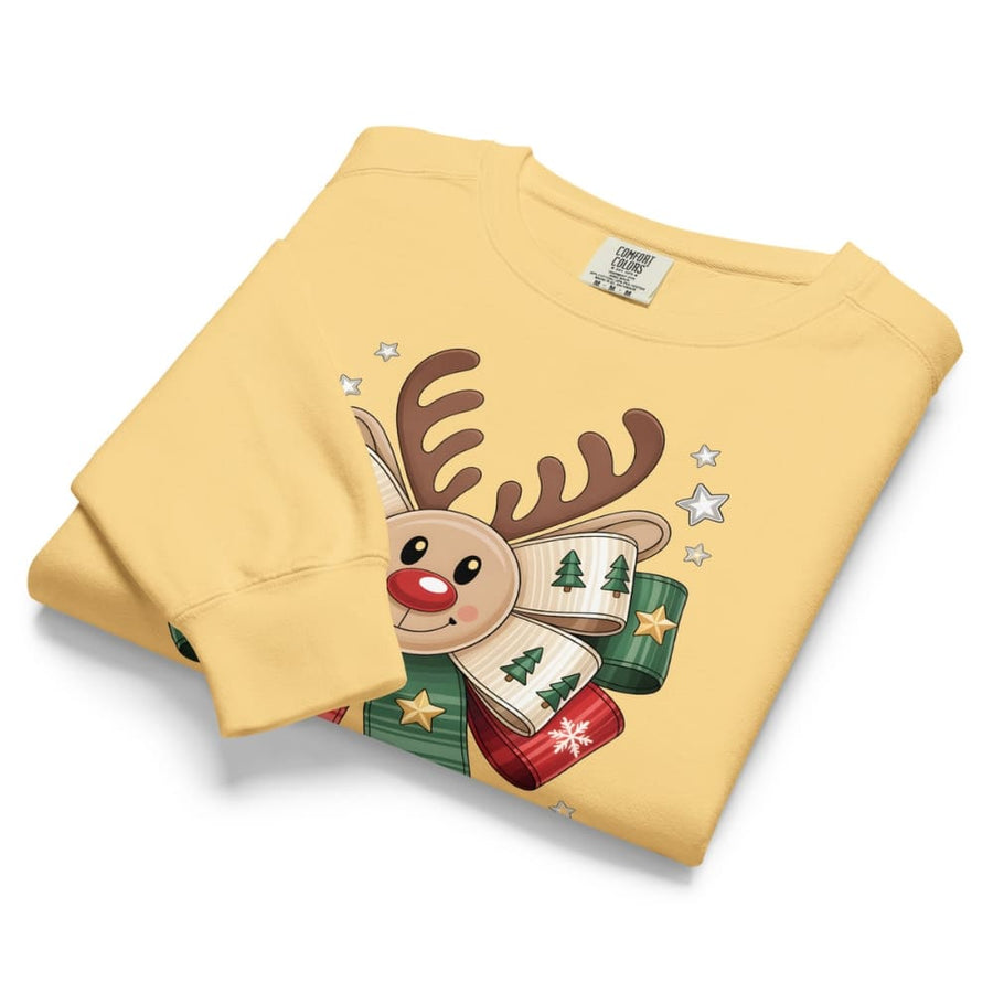 Folded yellow sweatshirt with a reindeer design on a white background