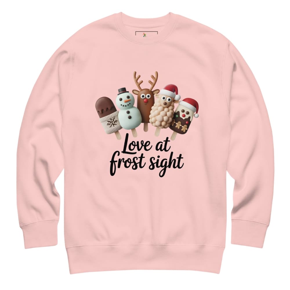 Pink sweatshirt with Christmas-themed illustrations and text on a white background