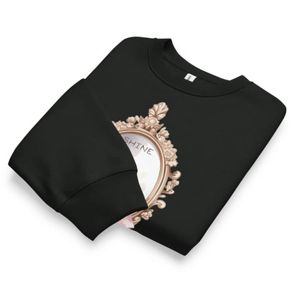 Black sweatshirt with decorative mirror design and 'SHINE' text on a white background