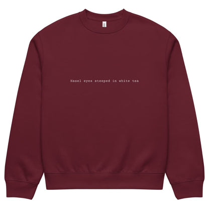 Maroon sweatshirt with text on a white background
