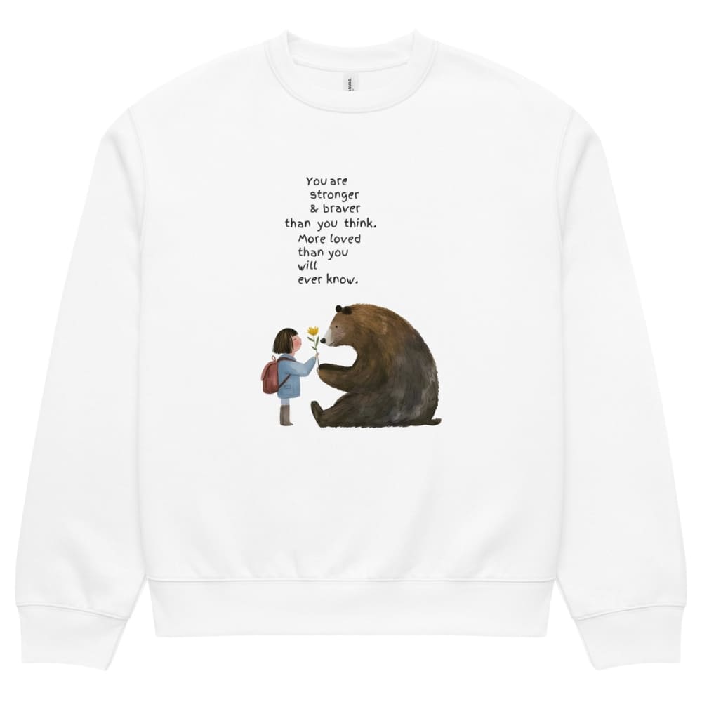 White sweatshirt with a graphic of a girl and bear holding hands and text on a white background
