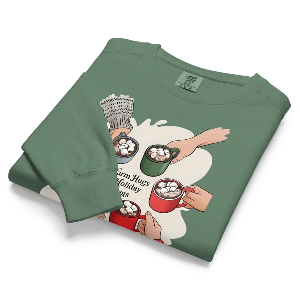 Folded green sweatshirt with graphic design of hands holding mugs on a white background