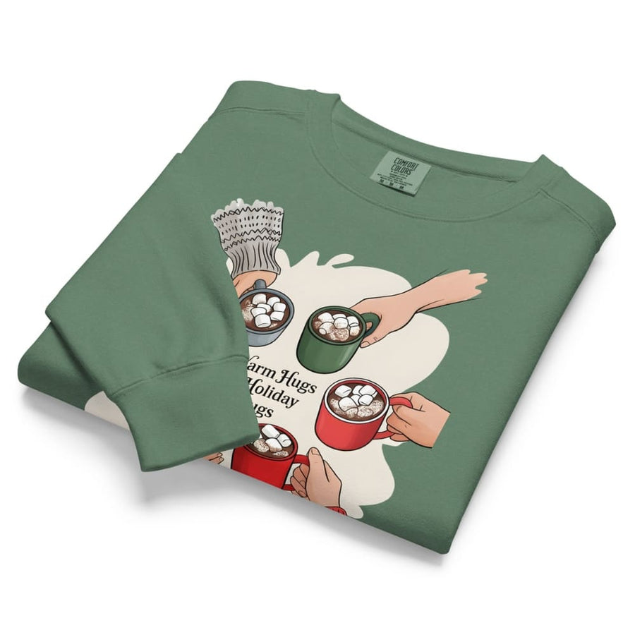 Folded green sweatshirt with graphic design of hands holding mugs on a white background