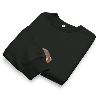 Folded black sweatshirt with a small graphic on a white background