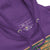 Close-up of a purple hoodie with a label on the chest area.