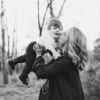 Black and white photo of a woman holding a child in an outdoor setting