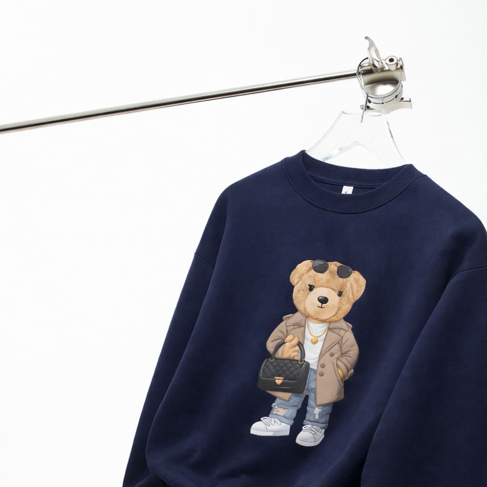 Navy blue sweatshirt with a teddy bear graphic on a white background