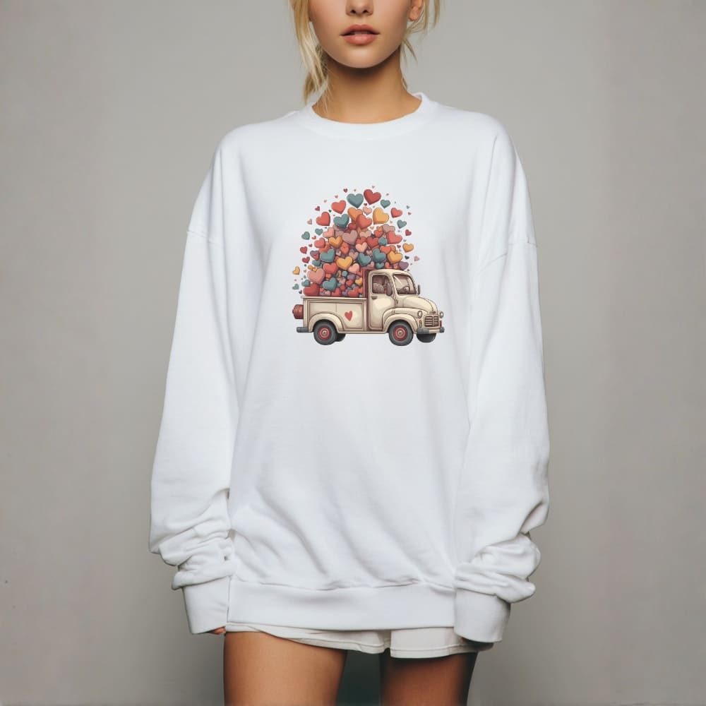 White sweatshirt with a truck and heart balloon design on a plain background