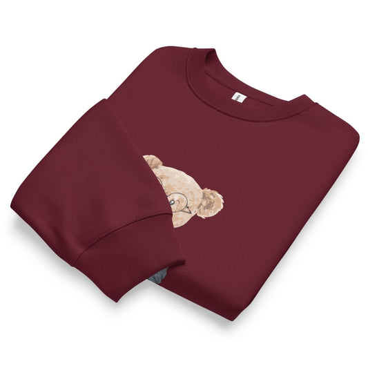 Folded maroon sweatshirt with a bear design on a white background