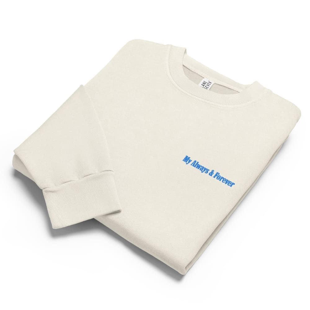 Folded beige sweatshirt with blue text on a white background