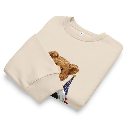 Beige sweatshirt with a teddy bear holding an American flag on a white background