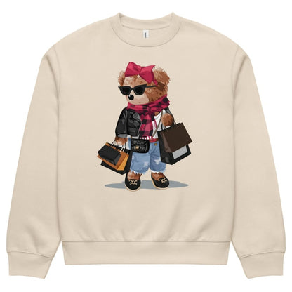 Beige sweatshirt with a teddy bear graphic wearing sunglasses, a pink bow, and holding bags on a white background.